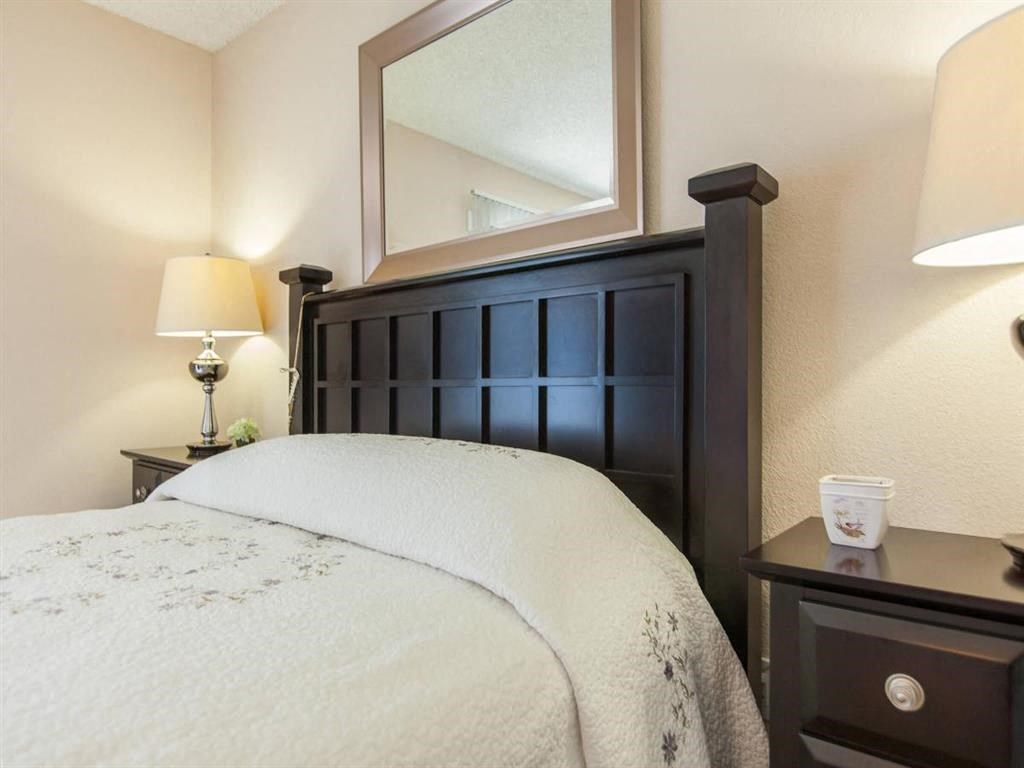 a bedroom with a bed and a mirror