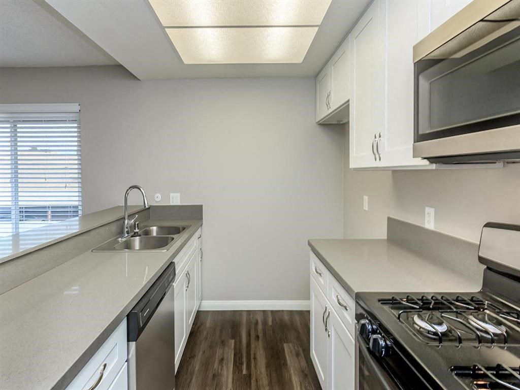 a kitchen with stainless steel appliances and white cabinets
