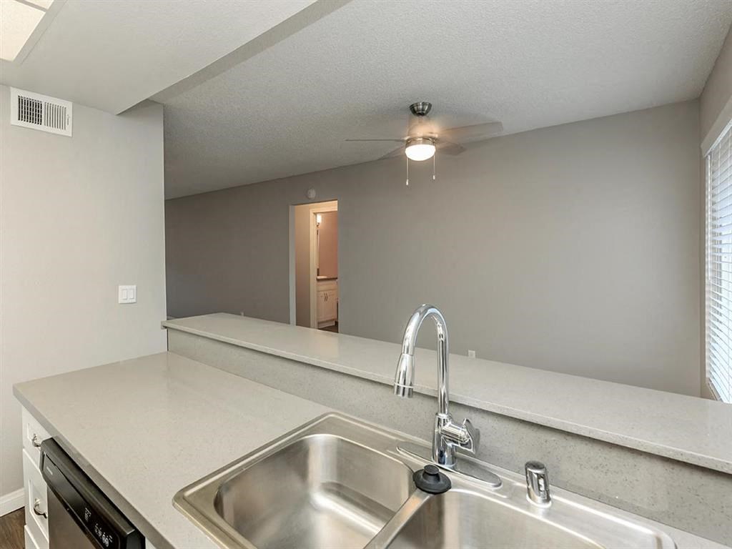a kitchen with a sink and a counter top