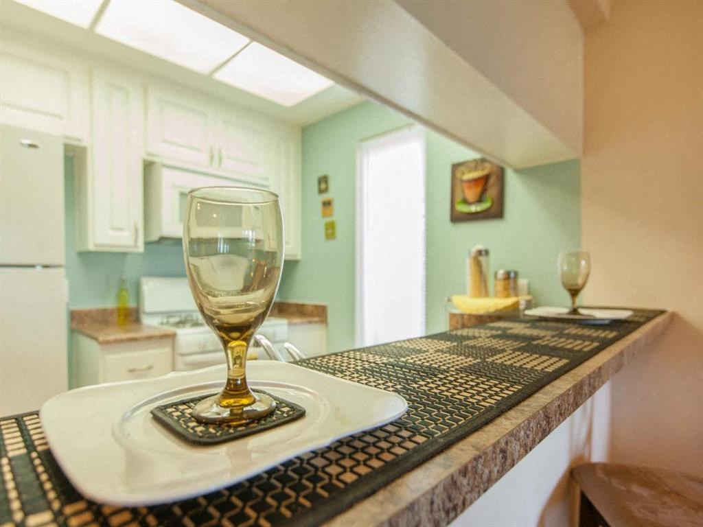 a glass of wine sitting on a kitchen counter