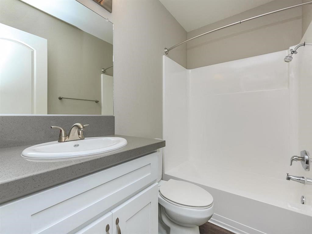 a white bathroom with a sink and a toilet
