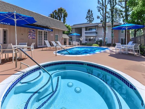 our apartments have a large pool and patio with umbrellas