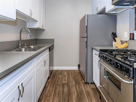 a kitchen with stainless steel appliances and white cabinets