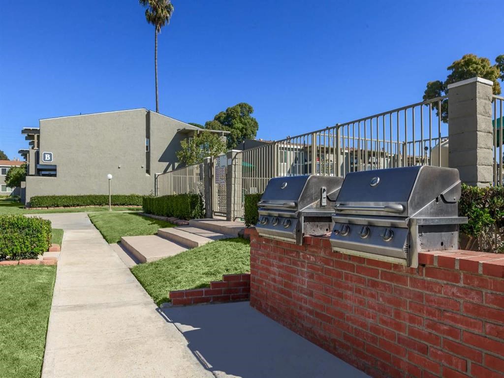 a brick wall with two grills in front of a building