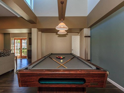 a pool table in the living room of a house