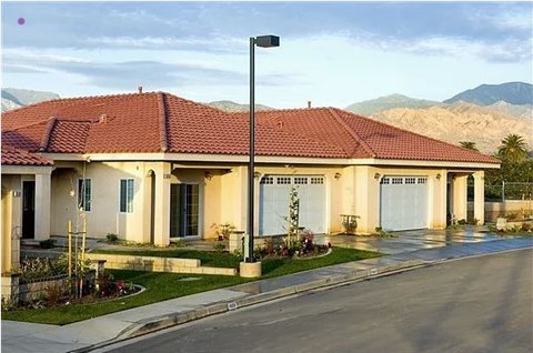 A house with a red roof and a street light in front.