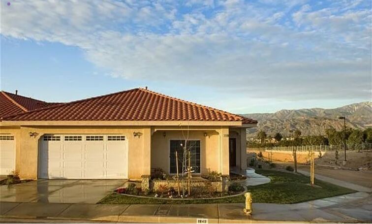 A house with a red tile roof and a garage door.
