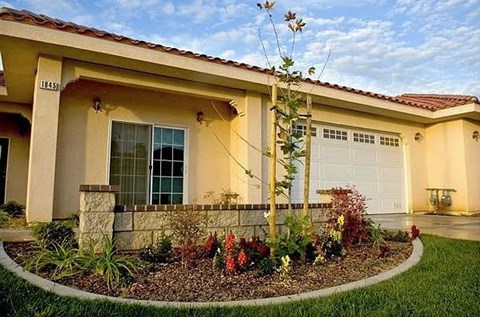 A house with a well-maintained garden in front.