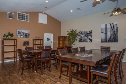 A dining room with a wooden table and chairs.