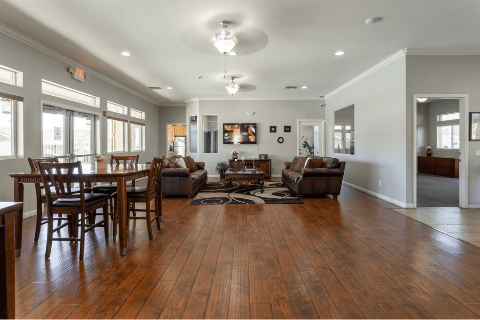 a large living room with a dining room table and chairs