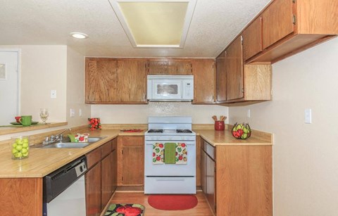 A kitchen with wooden cabinets and a white oven.