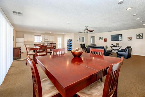 A dining room with a wooden table and chairs.