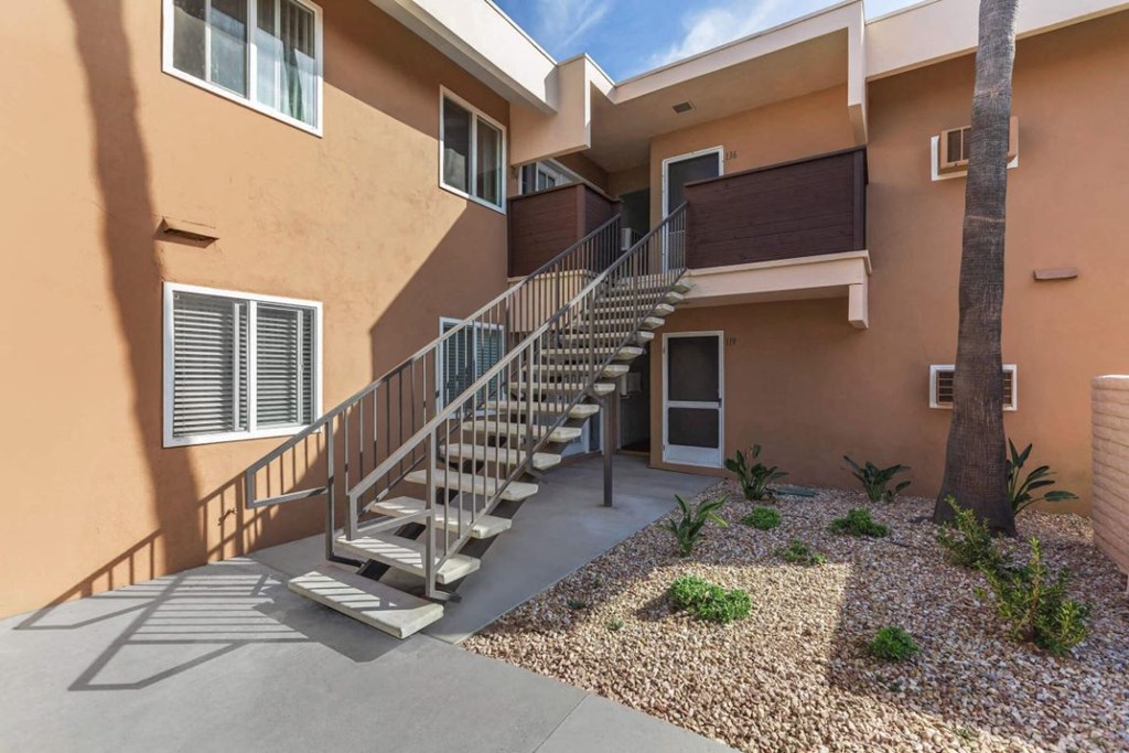 the stairway up to an apartment building with stairs