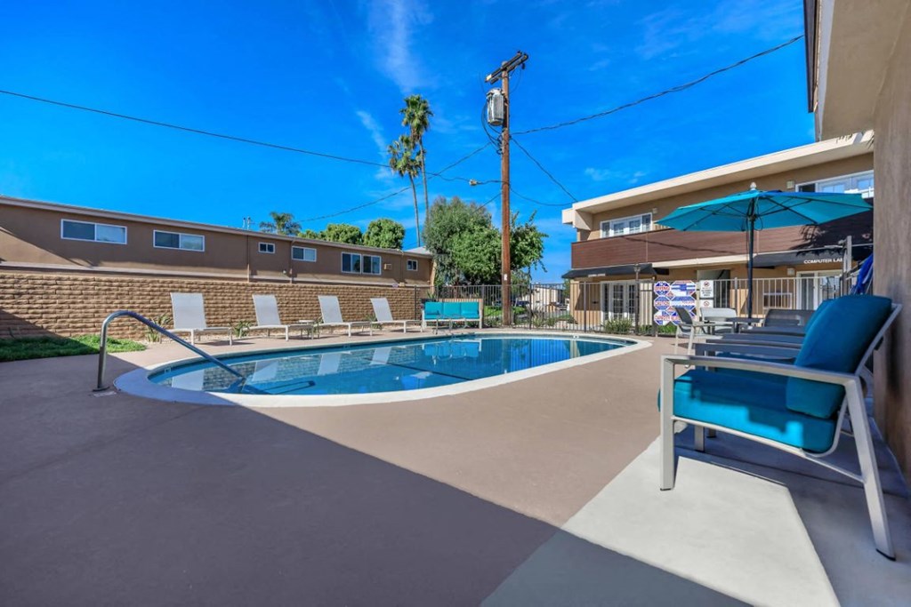 our apartments have a pool and a patio with chairs
