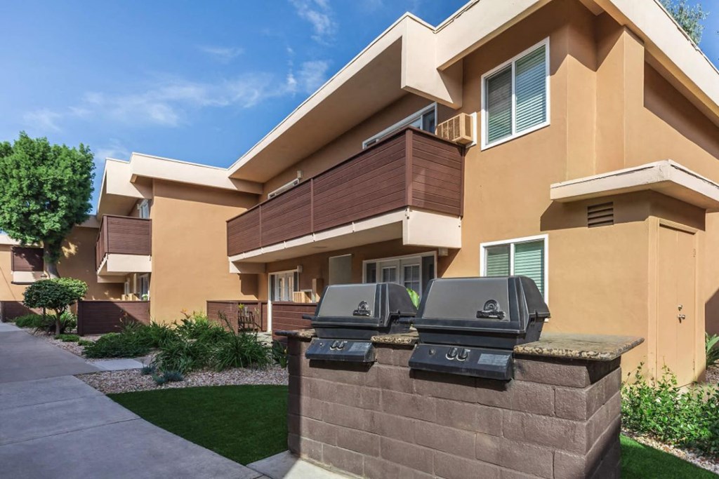 a building with two barbecue pits in front of it