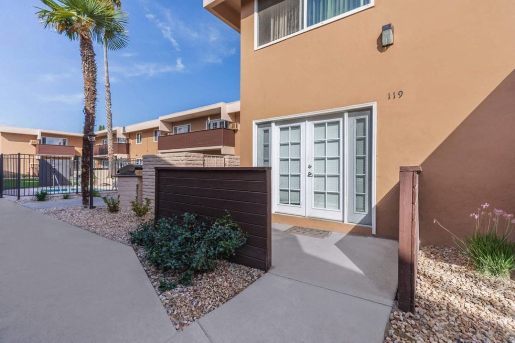 a garage door in front of a house with a palm tree