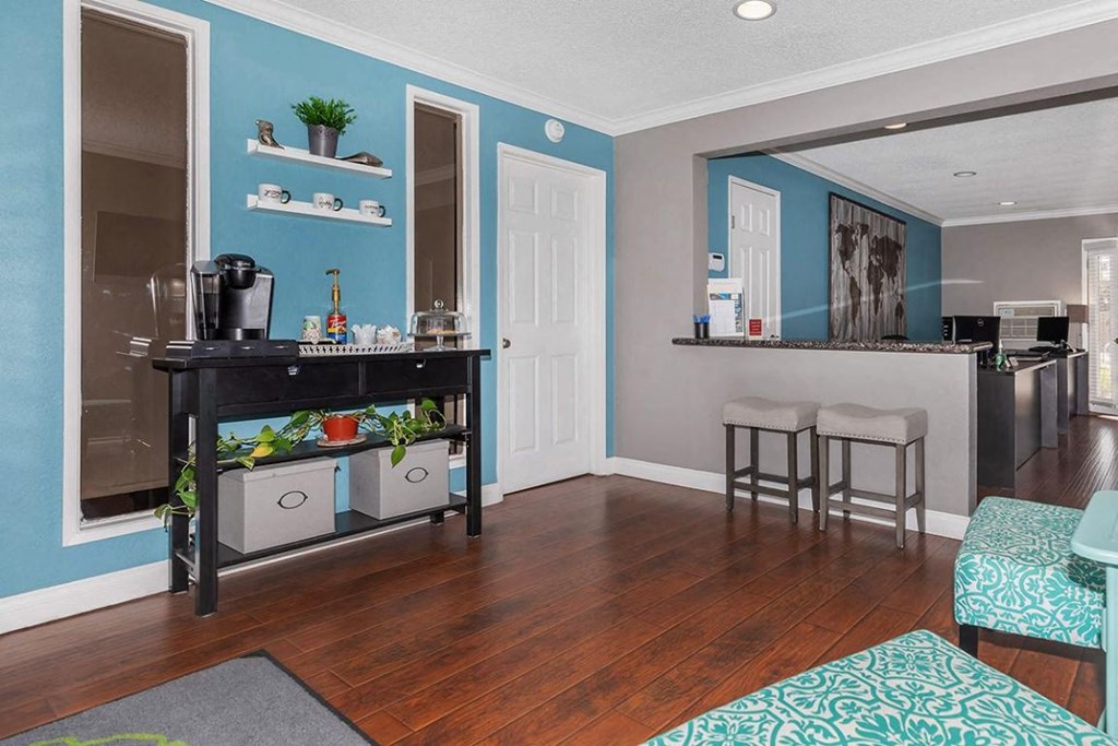 a living room with a bar and a kitchen