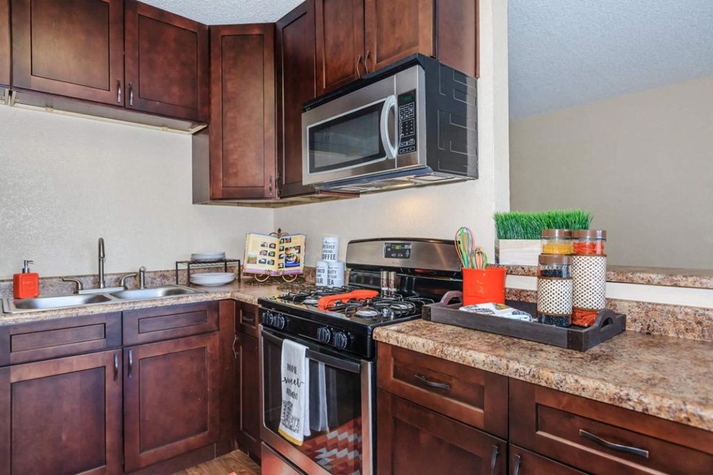 a kitchen with a stove microwave and a sink