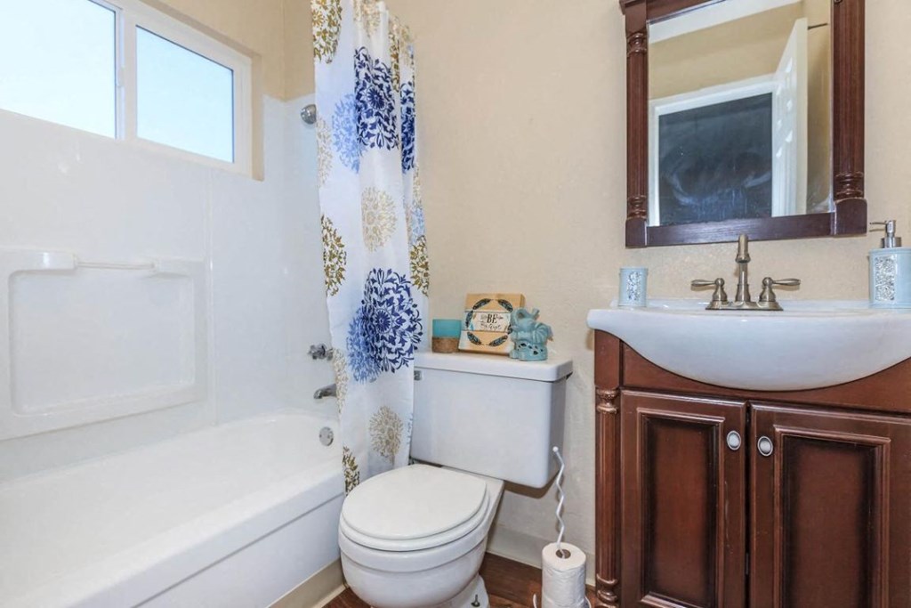 a bathroom with a toilet sink and bath tub