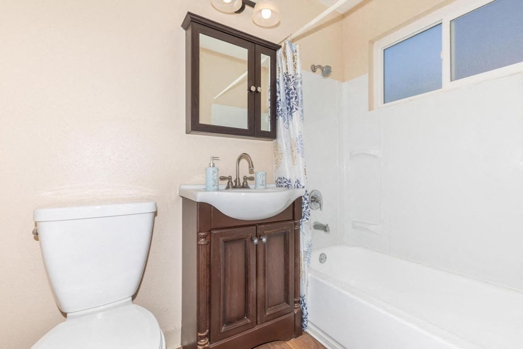 a bathroom with a toilet sink and a shower