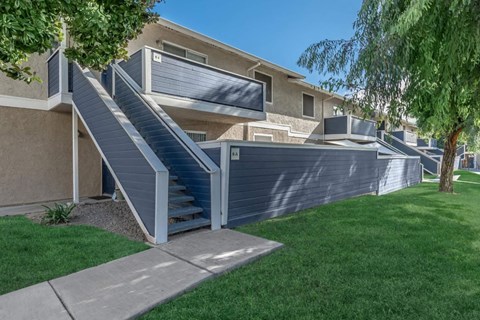 a retaining wall with stairs in front of a house