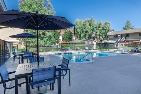 our apartments have a pool and tables with umbrellas