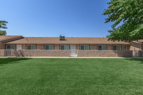 A building with a green lawn in front of it.