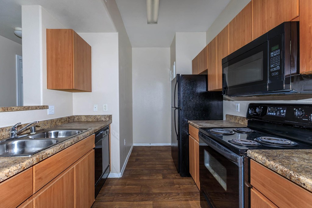 a kitchen with black appliances and granite counter tops