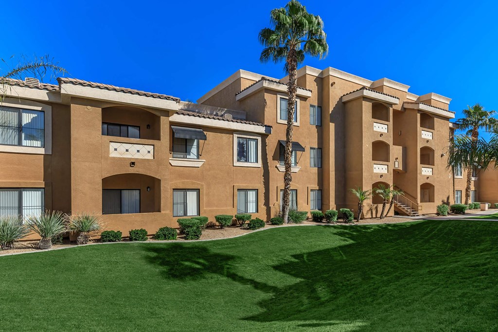 a large building with palm trees in front of it