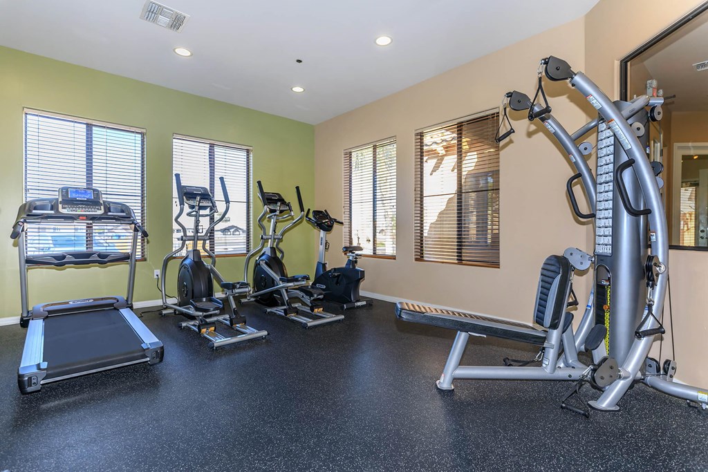 a gym with exercise equipment and windows
