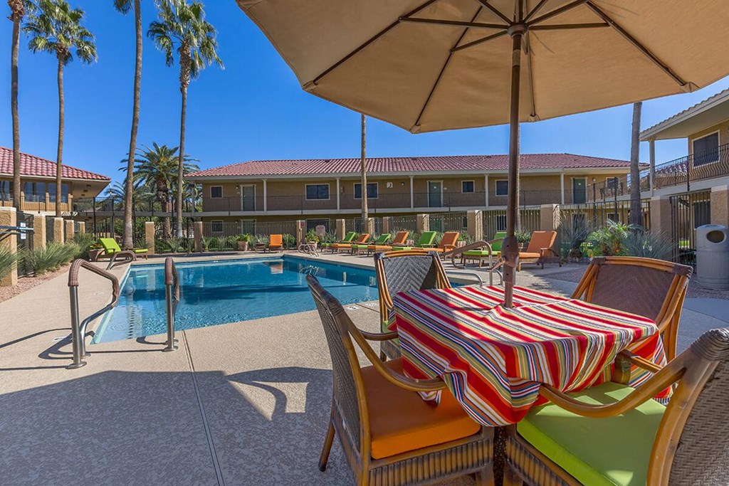 a swimming pool with a table and chairs