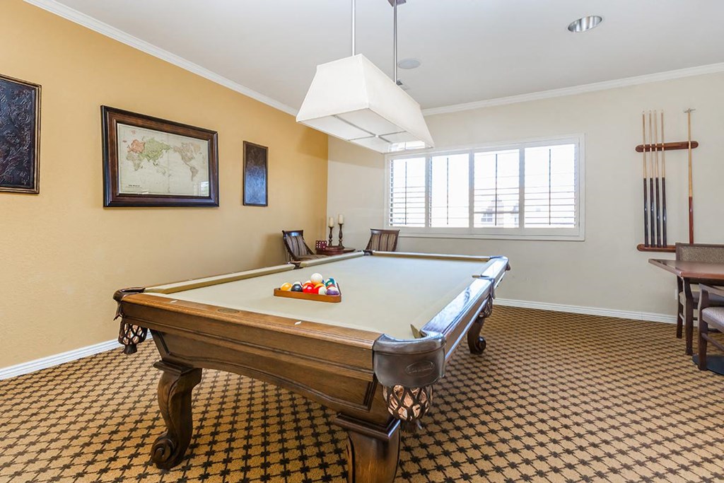 a game room with a pool table