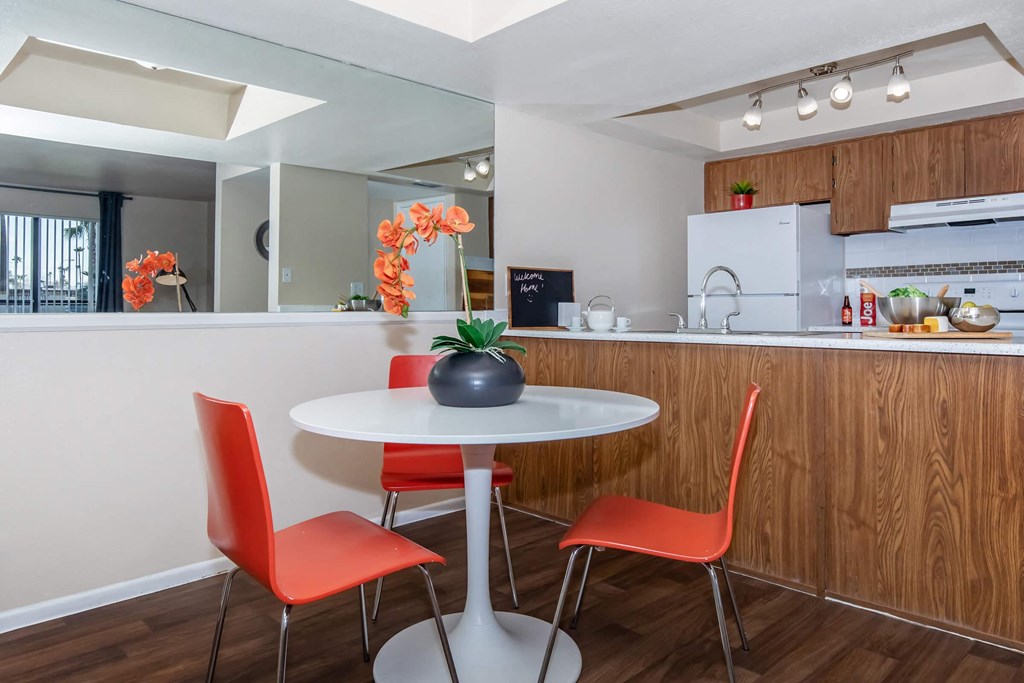 a kitchen and dining area with a table and chairs