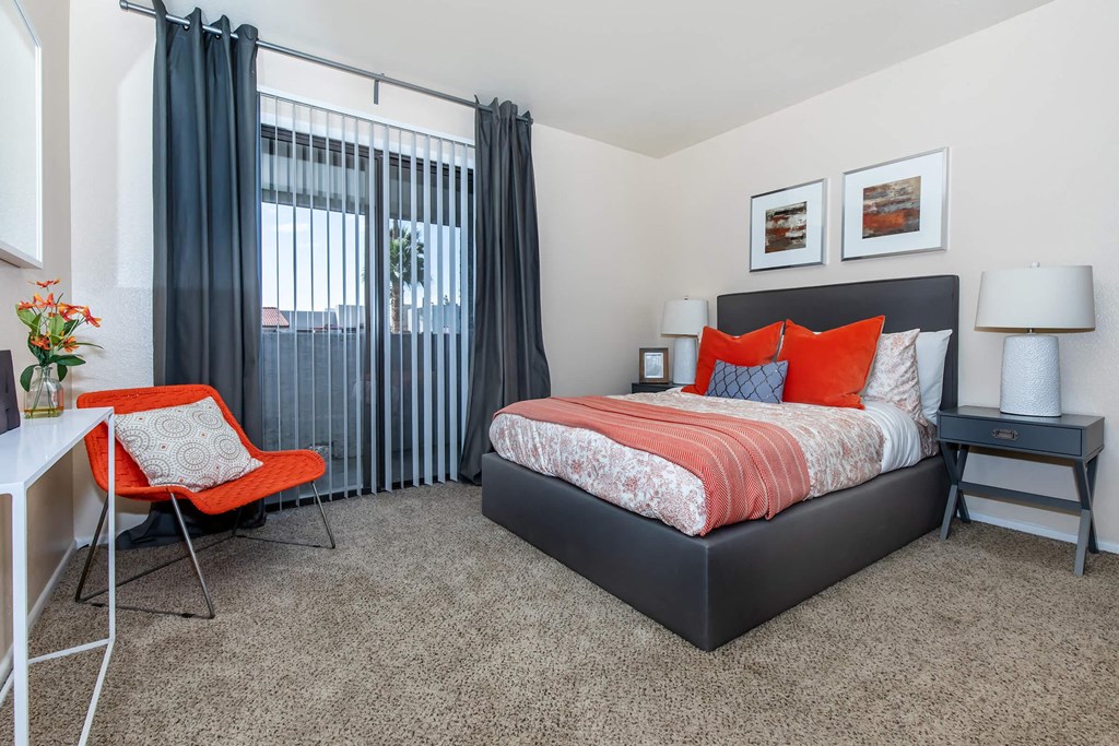 a bedroom with a bed and a desk with a chair