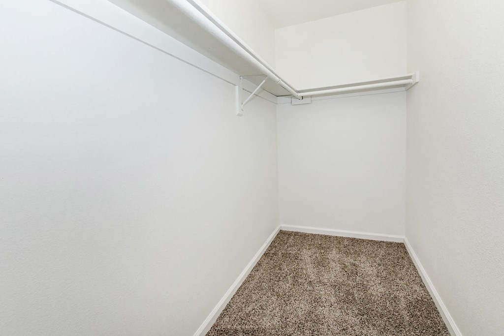 a empty room with a carpeted floor and white walls