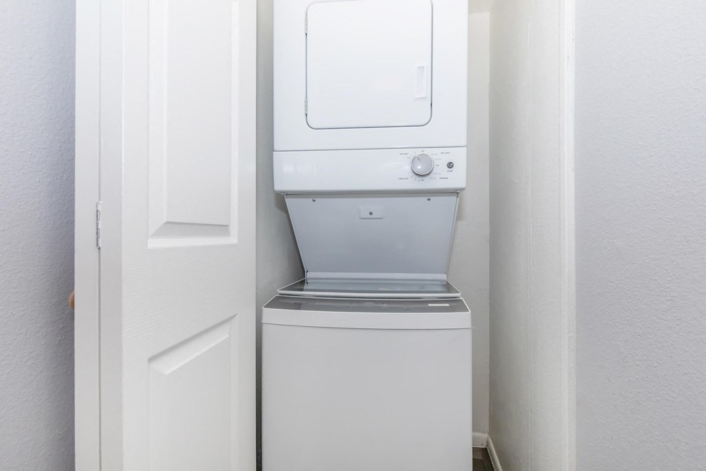 a white washer and dryer in a small closet