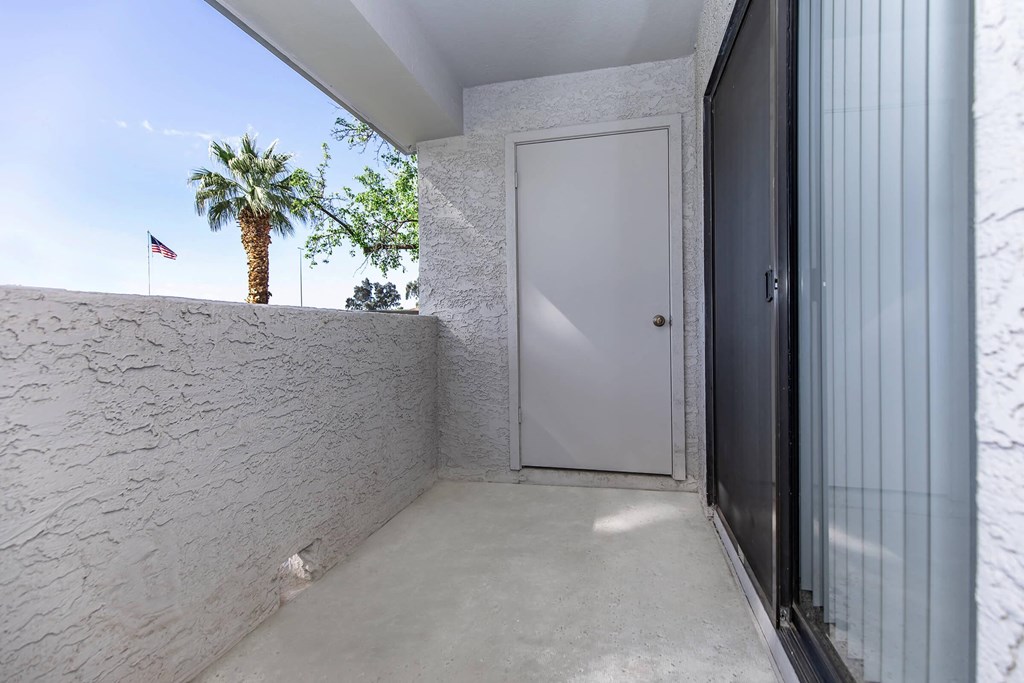 the door to the entrance of a building with a palm tree