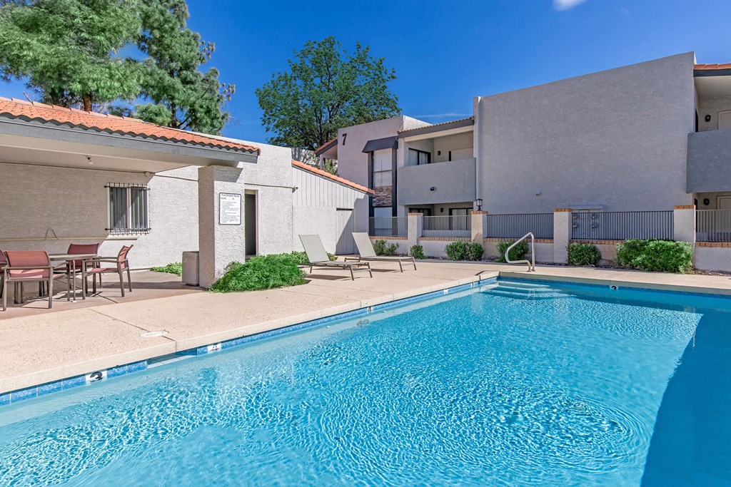 a swimming pool with a building in the background