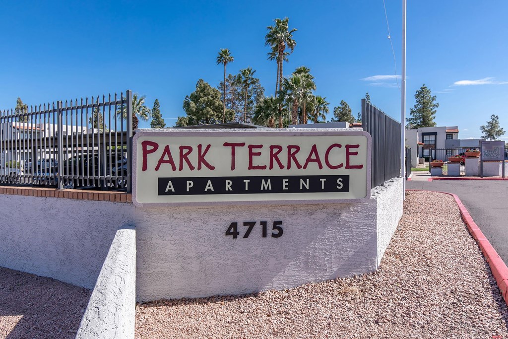 a sign for park terrace apartments in front of a gate