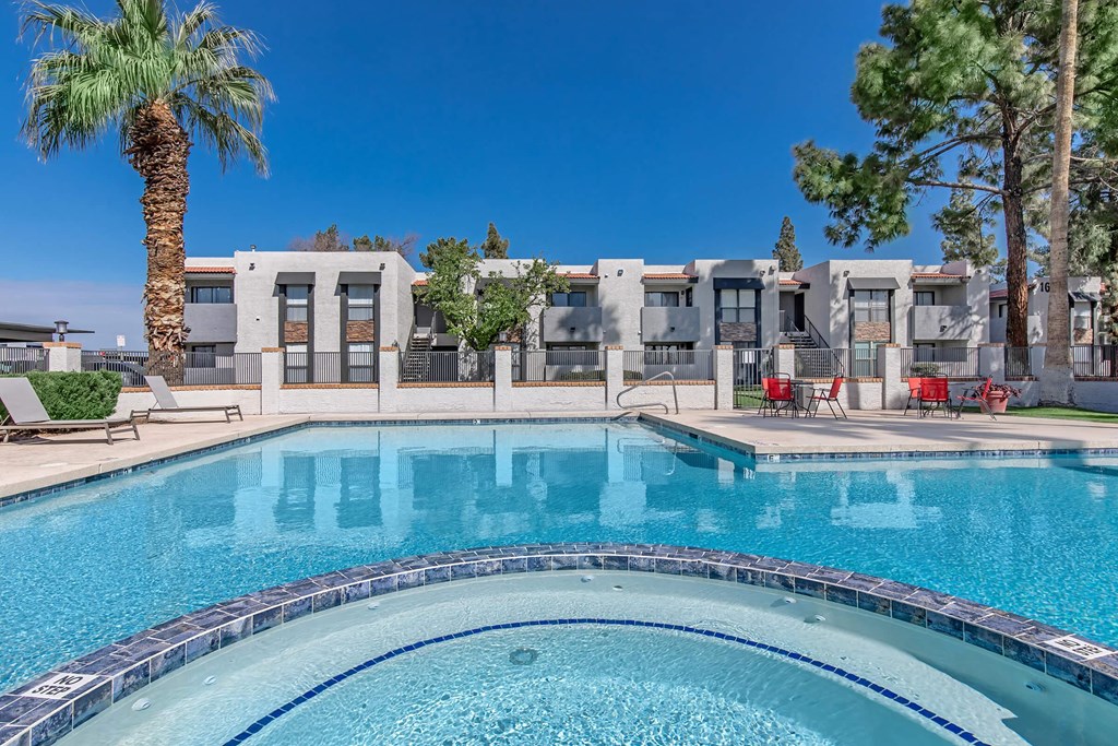 a swimming pool with apartments in the background