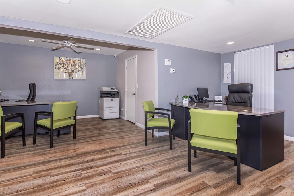 a office with a desk and chairs and a computer