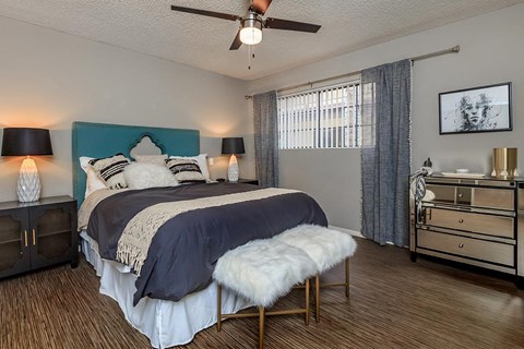 a bedroom with a bed and a ceiling fan