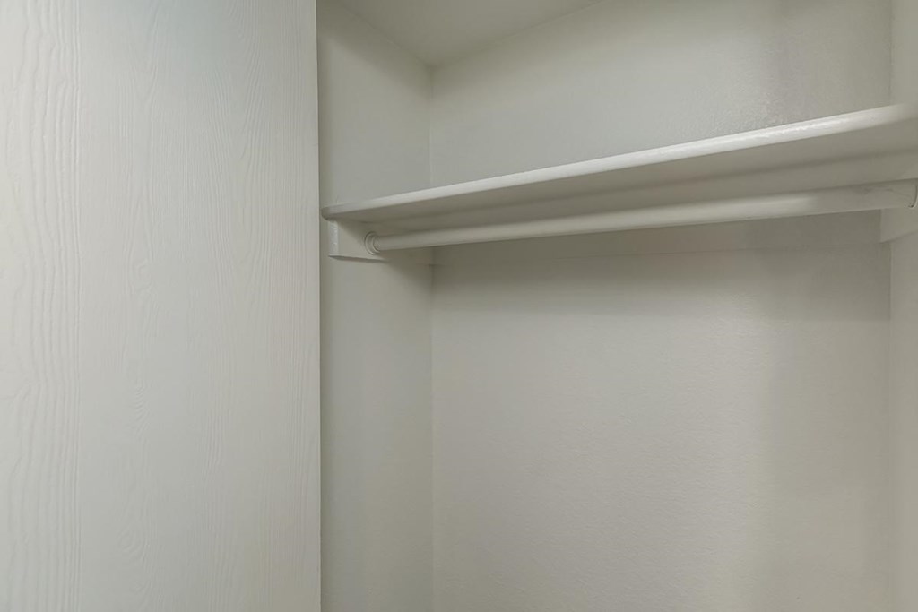 a white closet door with a white shelf above it