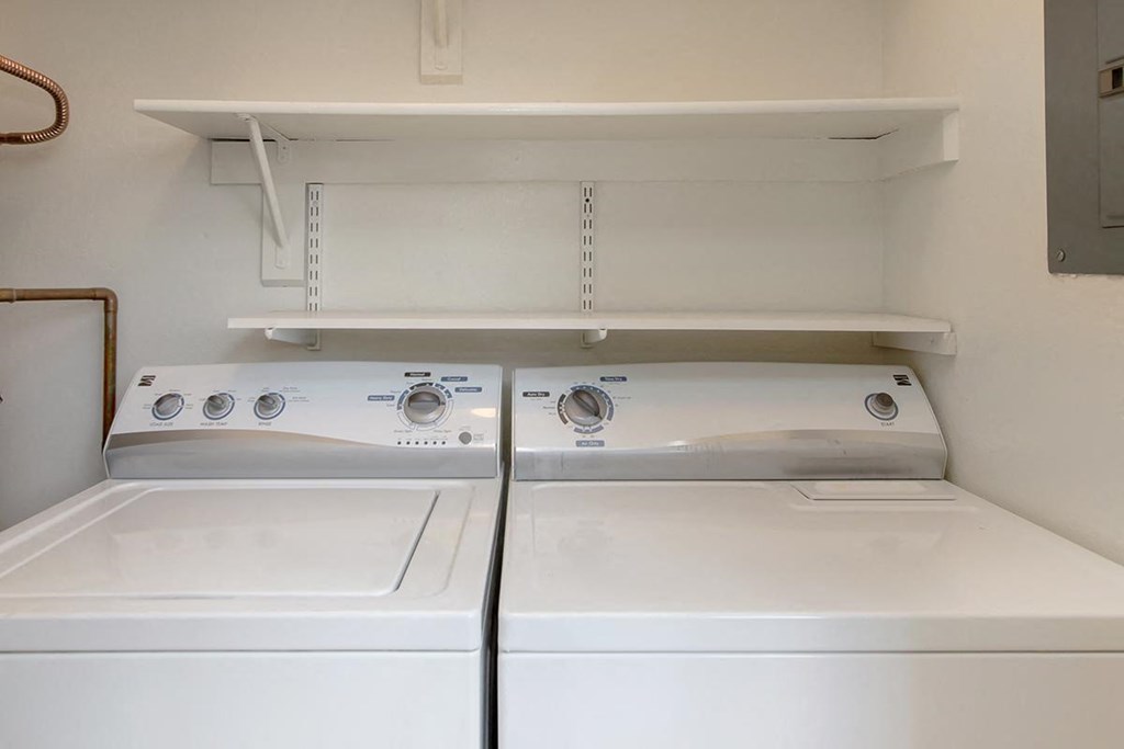 a washer and dryer in an empty laundry room