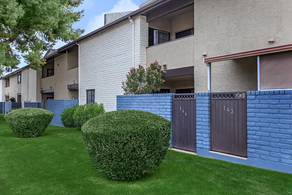 a blue brick wall in front of an apartment building