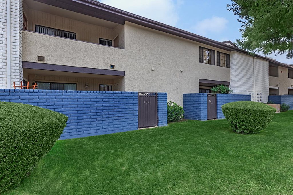 a blue brick retaining wall in front of a house