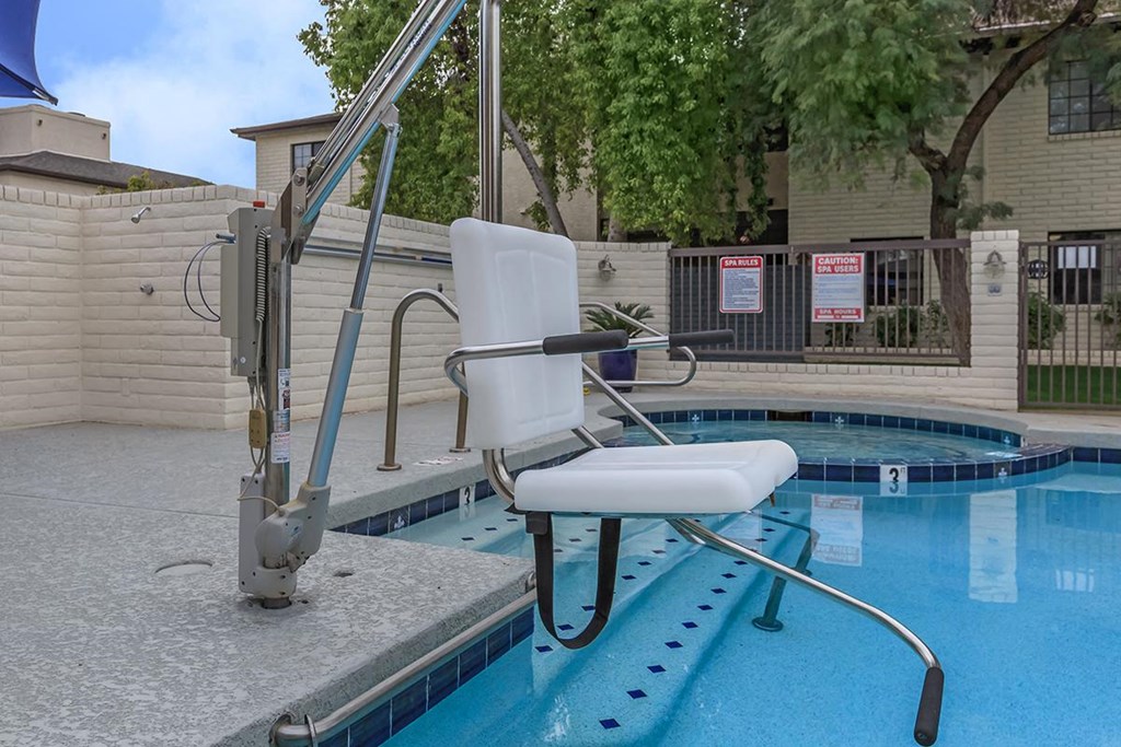 a swimming pool with a chair and a ladder in it