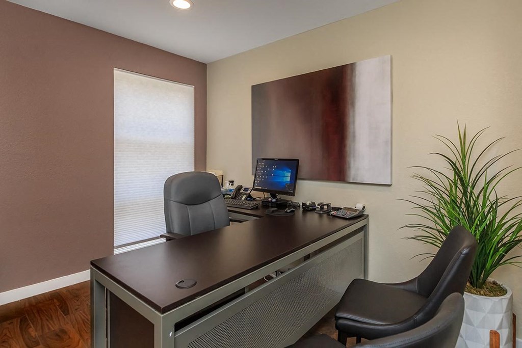 an office with a desk and a computer on it