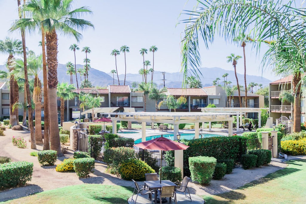 a resort with a pool and palm trees