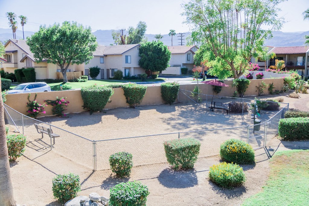 the backyard of a house with a garden and a fence